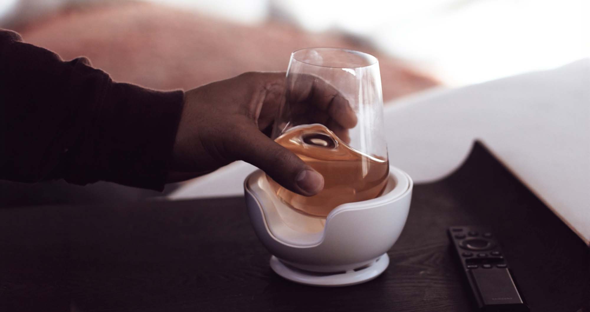 Man lifting a stemless wine glass from a VoChill wine glass chiller